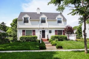 a two-story home with gabled roof in Cape Cod