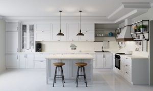a newly remodeled kitchen with white cabinetry and modern appliances