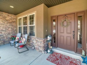 a brown-colored front door with surrounding sidelites